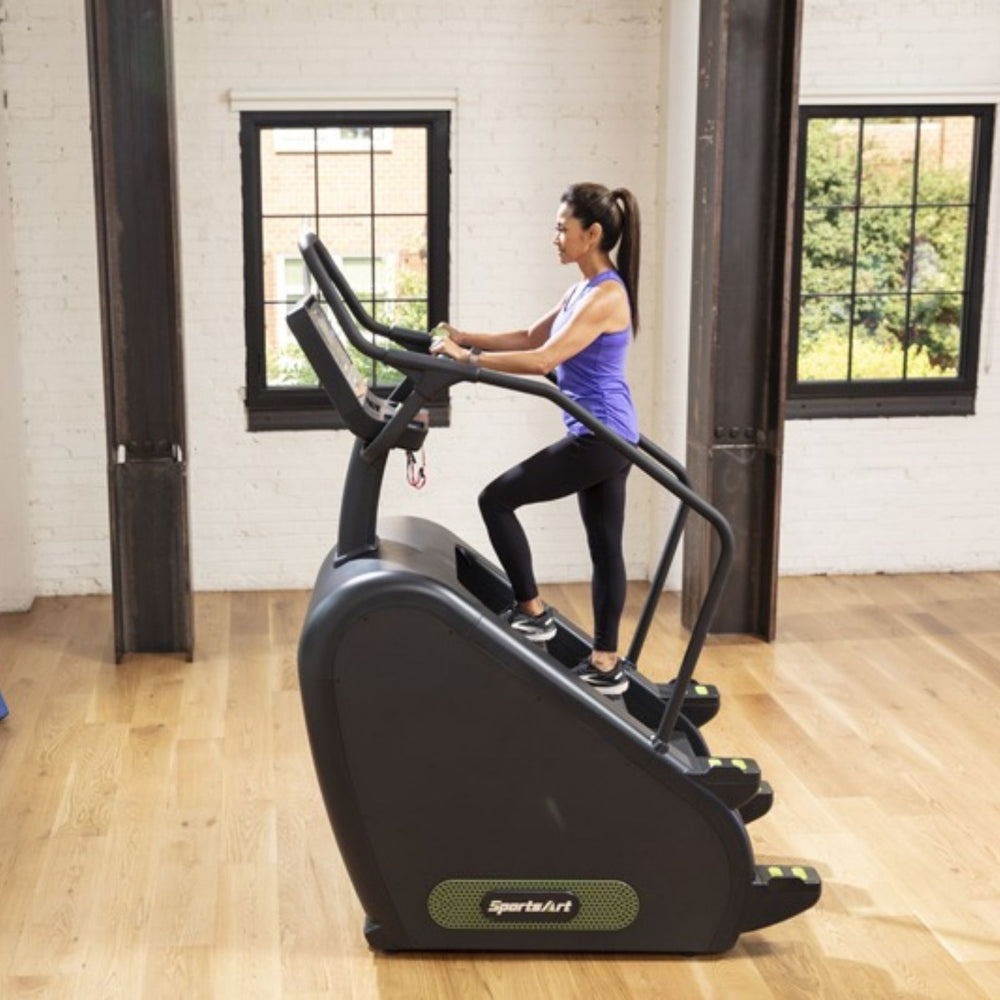 SportsArt ECO-POWR Stepper G778 side profile view with user climbing in studio setting
