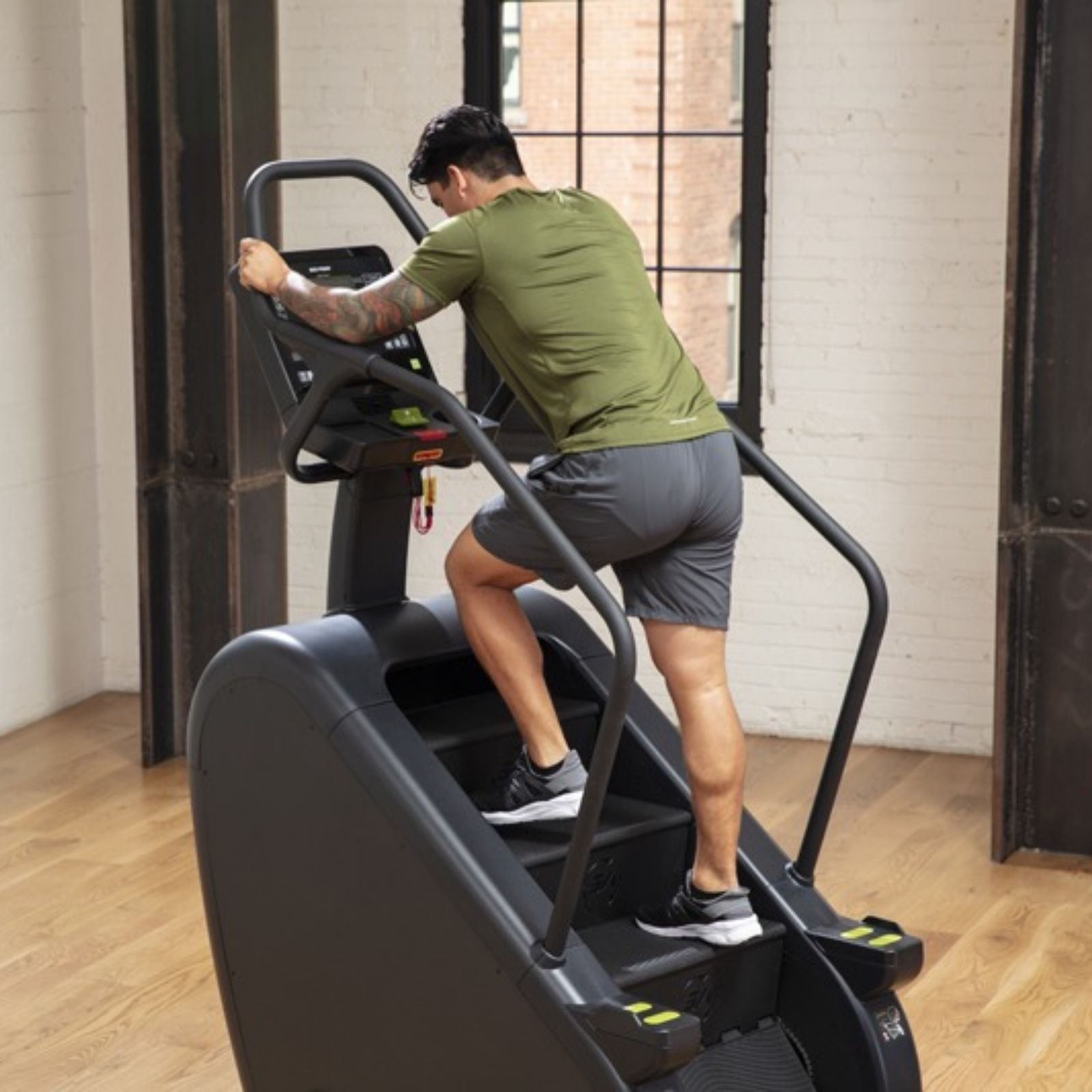 SportsArt ECO-POWR Stepper G778 rear view with male user climbing in commercial fitness studio