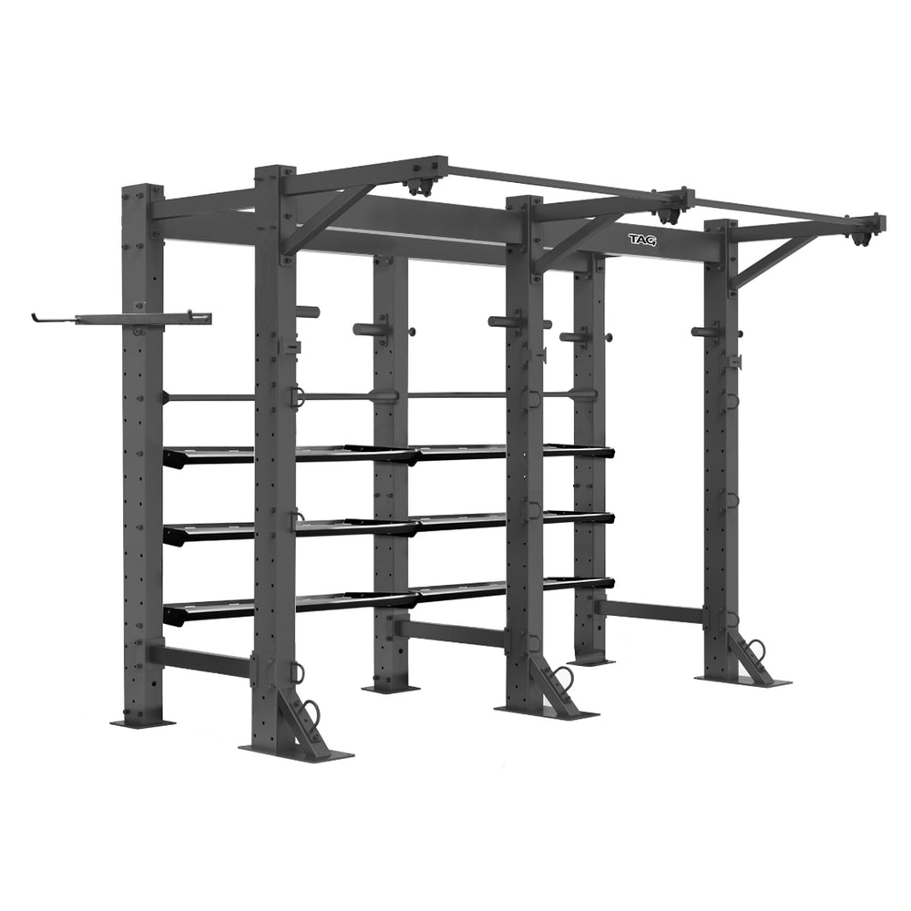 Tag Fitness Free Standing Fitness Double Bay Frame with pull-up bars, storage trays, ball rack, and multiple functional training anchor points. Black metal fitness power rack on a white background