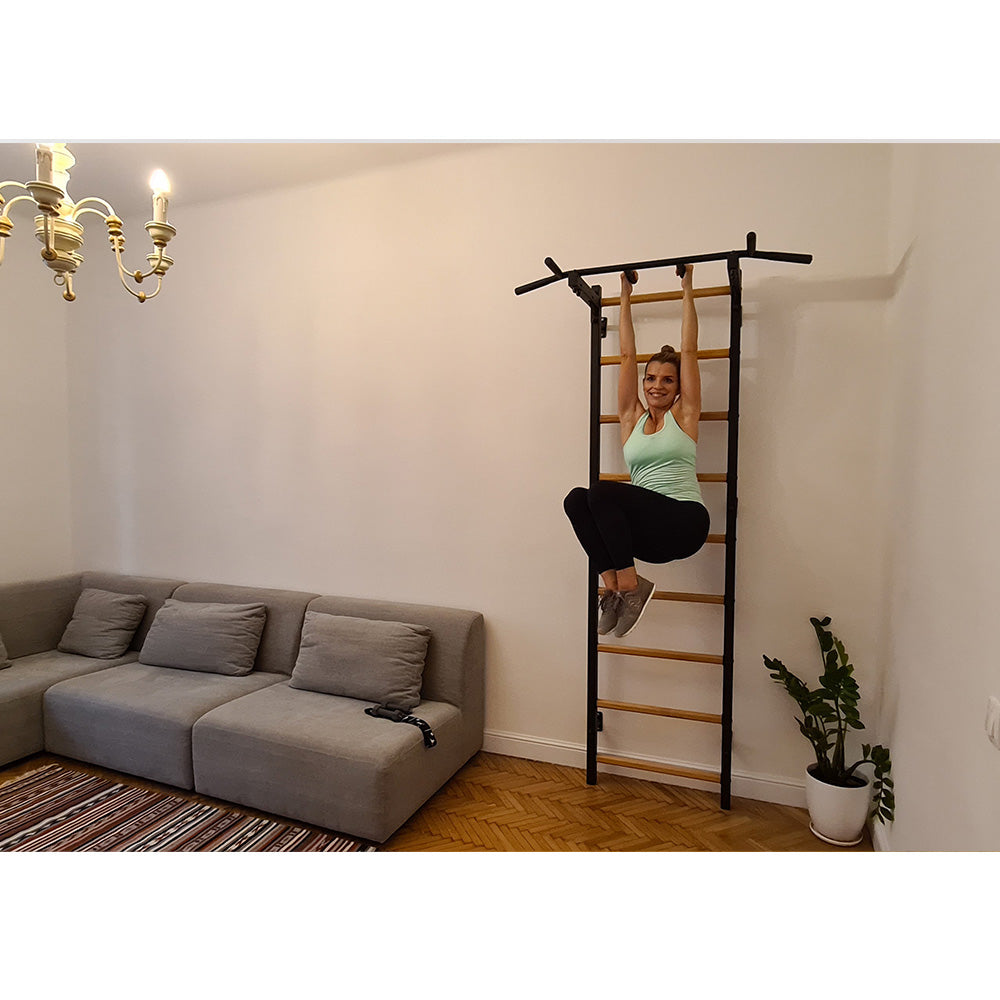 BenchK Wall Bar 721B in the living room with female user exercising