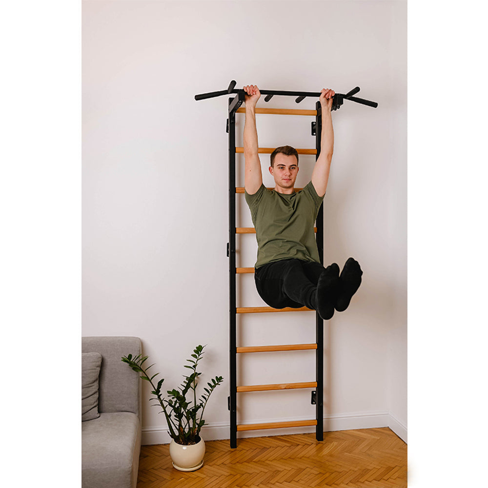 BenchK Wall Bar 721B inside a home with male user exercising leg lifts 