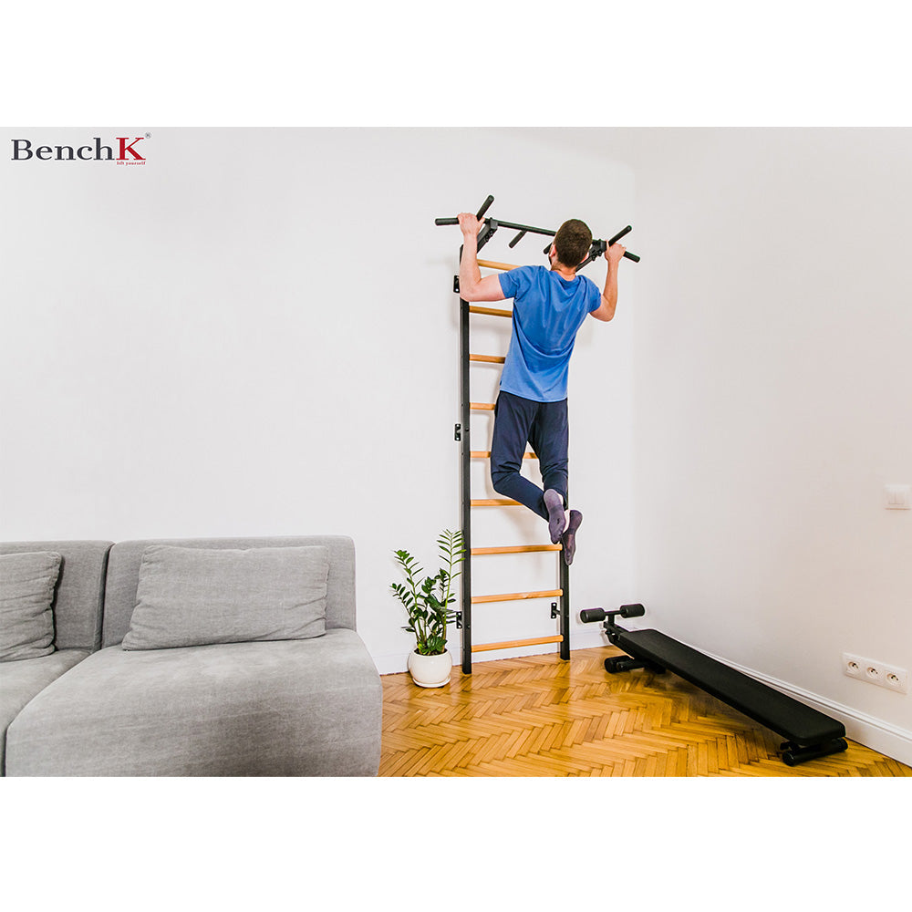 BenchK Wall Bar 721B inside a home with user exercising a pull up 