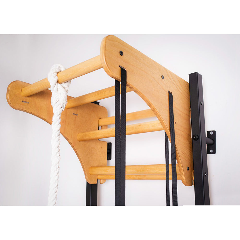 BenchK Wooden Pull Up Bar PB076 on a matte black wall bar with accessories hanging from the wooden pull up bar