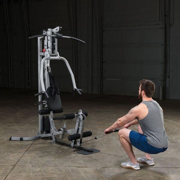 Body-Solid Powerline Single Stack Home Gym BSG10X male model uses the squat row with the lower pulley 