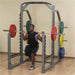 Body-Solid Proclub Multi Squat Rack with model and weight plates at the gym