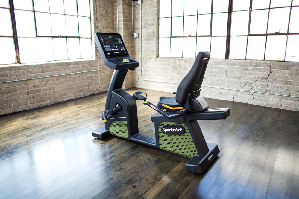 SportsArt Status Eco-Powr Recumbent Cycle G576R side angle view inside a windowed home gym 