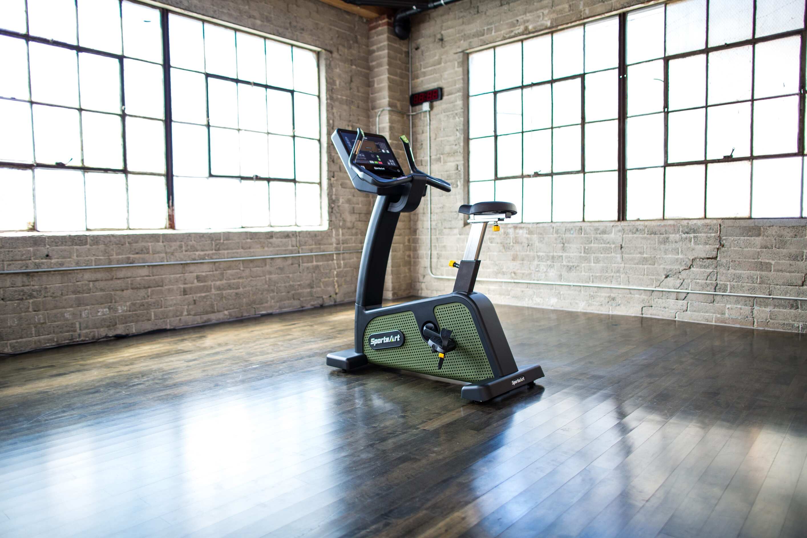 SportsArt Status Eco-Powr Upright Cycle G576U side view inside a home gym setting 