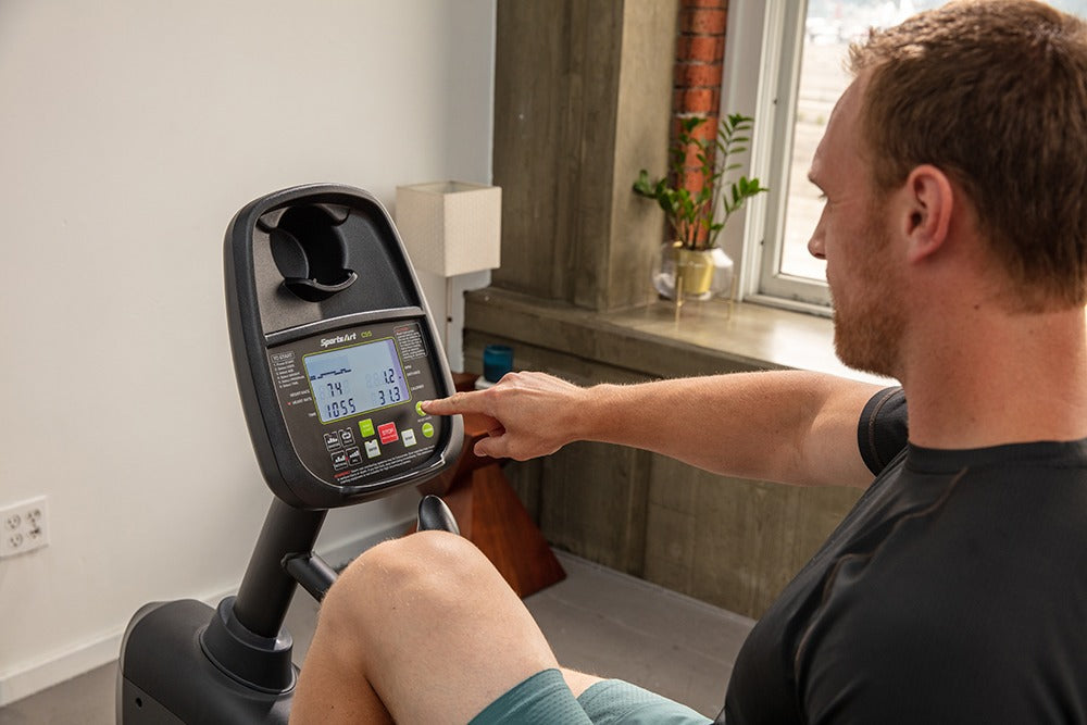 SportsArts Residential Recumbent Bike C55R male users interacting with the console 