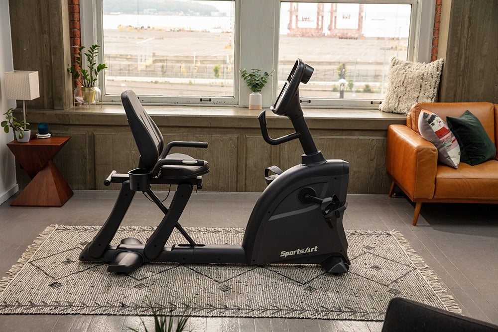SportsArts Residential Recumbent Bike C55R side view inside a living room setting 