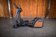SportsArts Status Eco-Natural Elliptical E876 side view with front end toward the left hand side 